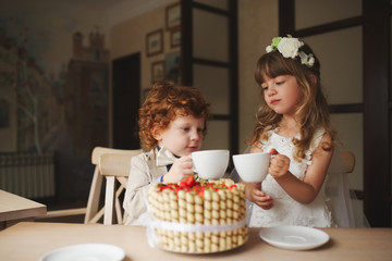 boy and girl having tea party in cafe