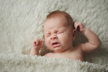 cute little sneezing baby at home