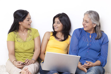 Three generational family discussing while shopping online 