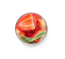 Glass with cold lemonade with strawberry on white background