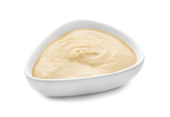 Bowl of delicious mustard sauce on white background