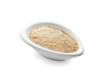 Bowl of delicious Dijon mustard sauce on white background