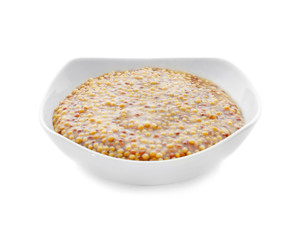 Bowl of delicious Dijon mustard sauce on white background