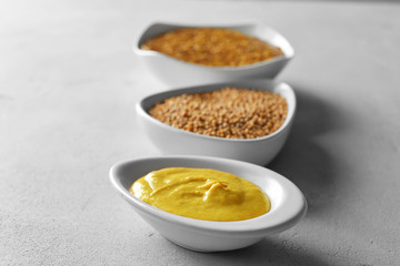 Gravy boat with delicious mustard sauce on table