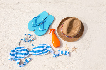 Fototapeta na wymiar Set of beach accessories on sea shore. Summer vacation concept