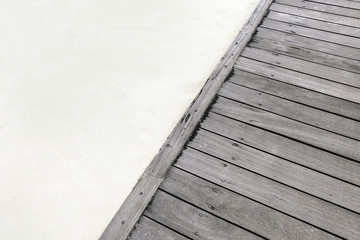 Part of wooden pontoon and sand on beach in summer day