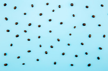 Stylish set: coffee beans on pastel blue background. Flat lay. Top view.