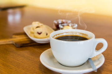 A cup of  coffee  on the wooden  table.