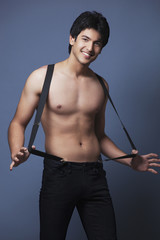 Fototapeta premium Shirtless man wearing suspenders 