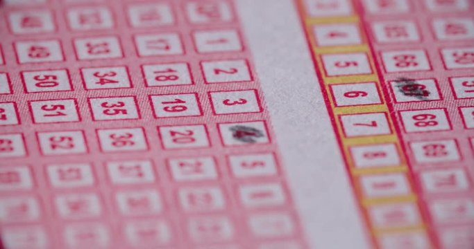 Lotto Ticket Pencil in Numbers Down Close Up. a close up of the tip of a pencil filling in lotto number boxes moving from right to left
