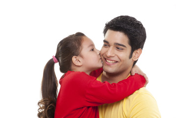 Close-up of girl kissing her father 