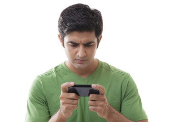 Close-up of smart guy reading text message over white background 