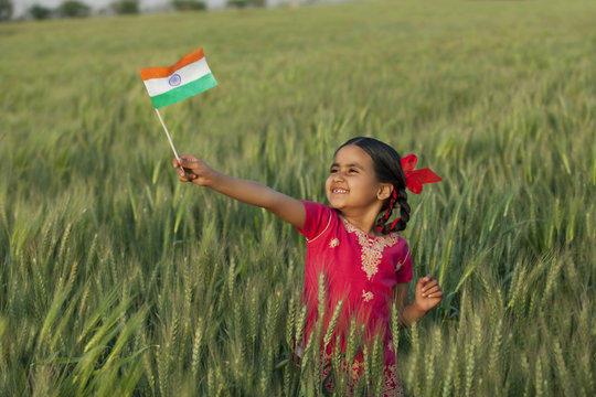 Cheerful little girl holding Indian flag 