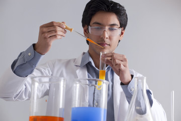 A male researcher at work using a pipette 