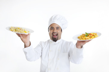 Portrait of chef holding plates with pasta