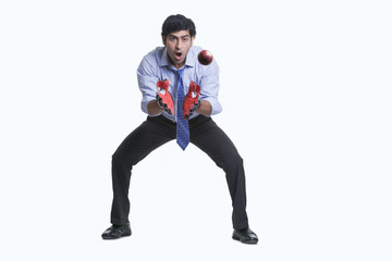 Wicket keeper catching cricket ball 