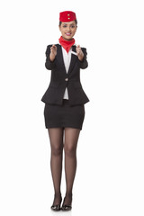 Flight attendant gesturing towards exits isolated over white background 