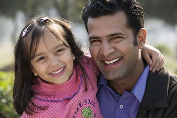 Father and daughter smiling 