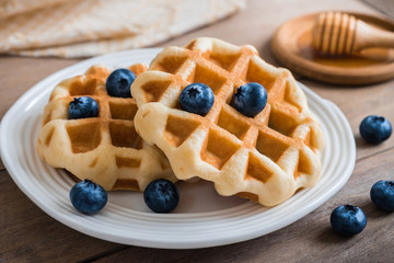 Waffle with blueberry on plate