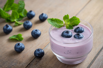 Yogurt with fresh blueberries in glass