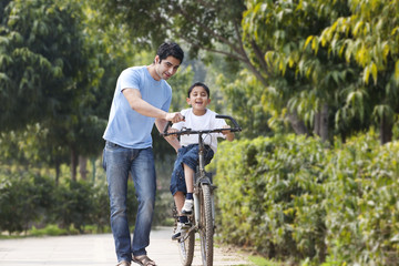 Father and son with a bicycle 