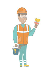 Hispanic house painter in hard hat holding paintbrush