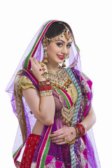 Portrait of beautiful bride smiling against white background