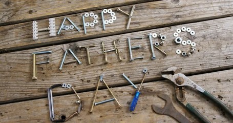 Happy fathers day text with various work tool arranged on wooden plank