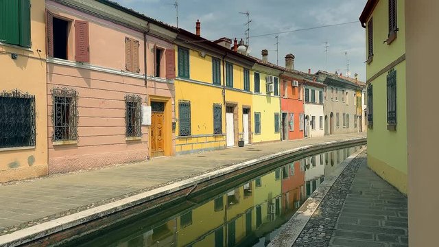 speed up shot of romantic houses and colorful buildings lining water channel in romantic lagoon village, undiscovered touristic attraction in Italy