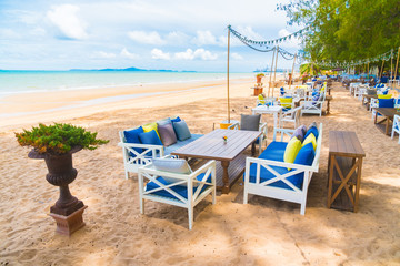 Chair and table dinning on the beach and sea with blue sky