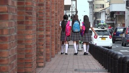 Obraz premium Female Teen Students Walking With Backpacks