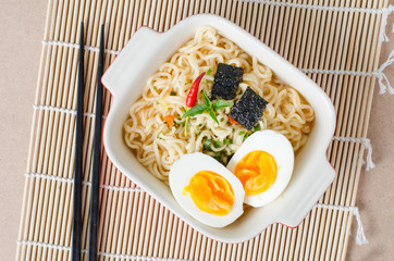 Instant noodles with boiled egg and seaweed in a bowl ready to eating,popular Asian food
