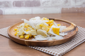 Sweet Corn with coconut and sugar on wooden plate