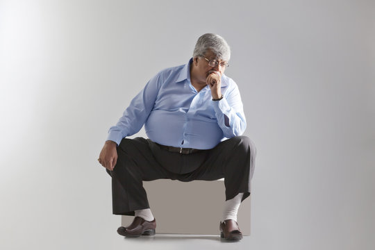 Obese old man thinking