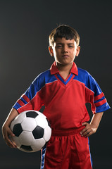 Fototapeta premium A boy holding a football 