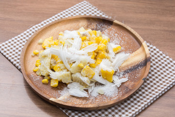 Sweet Corn with coconut and sugar on wooden plate