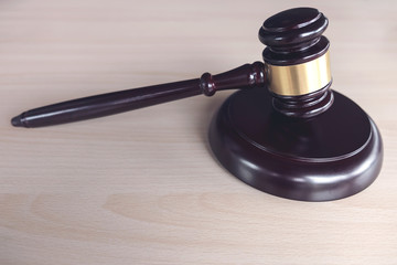 Close up of gavel on wooden table in a courtroom striking, Law and justice concept