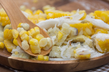 Sweet Corn with coconut and sugar on wooden plate