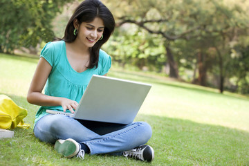 Young college student using laptop 