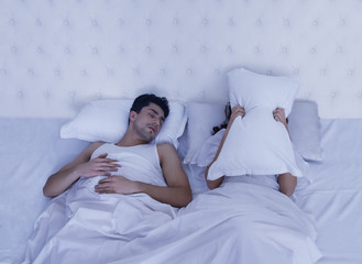 Woman covering her face with pilllow