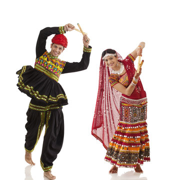 Couple performing dandia dance 