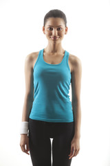 Portrait of a woman in sportswear standing against white background