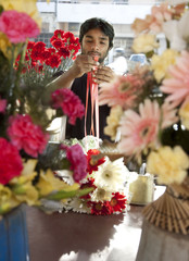 Florist tying a ribbon on a bouquet 