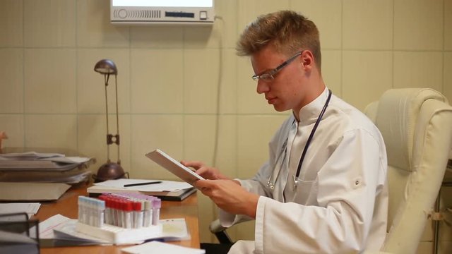 Doctor working on samples in the office and showing bad ones to the camera
