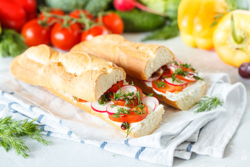 Summer sandwiches with baguette, cheese and tomatoes