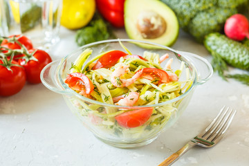 Zucchini pasta with shrimps and avocado.