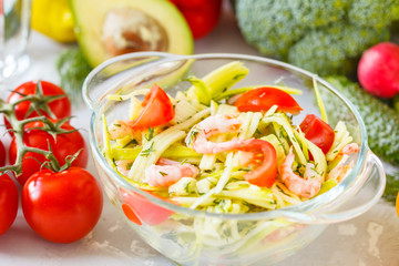 Zucchini pasta with shrimps and avocado.