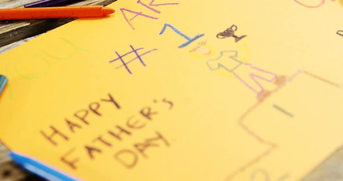 Paintings and happy fathers day message on paper