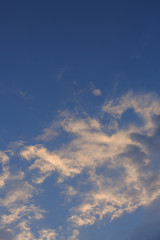 beautiful clear blue sky with golden sunshine on fluffy cloud