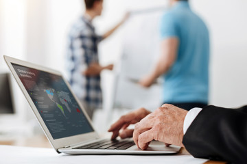 Neat male hands typing on a laptop keyboard